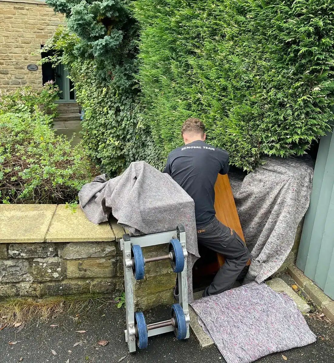 Moving a piano down a flight of stairs