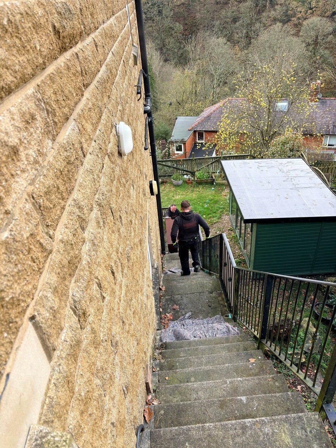 Piano disposal up a flight of outside steps in Manchester