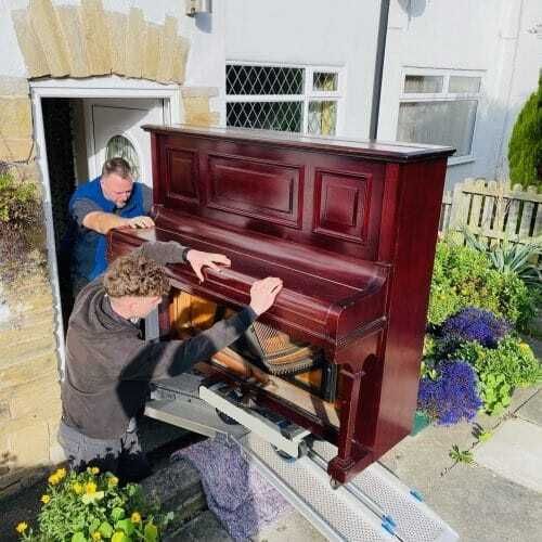 Piano lifted over a wall where access was difficult