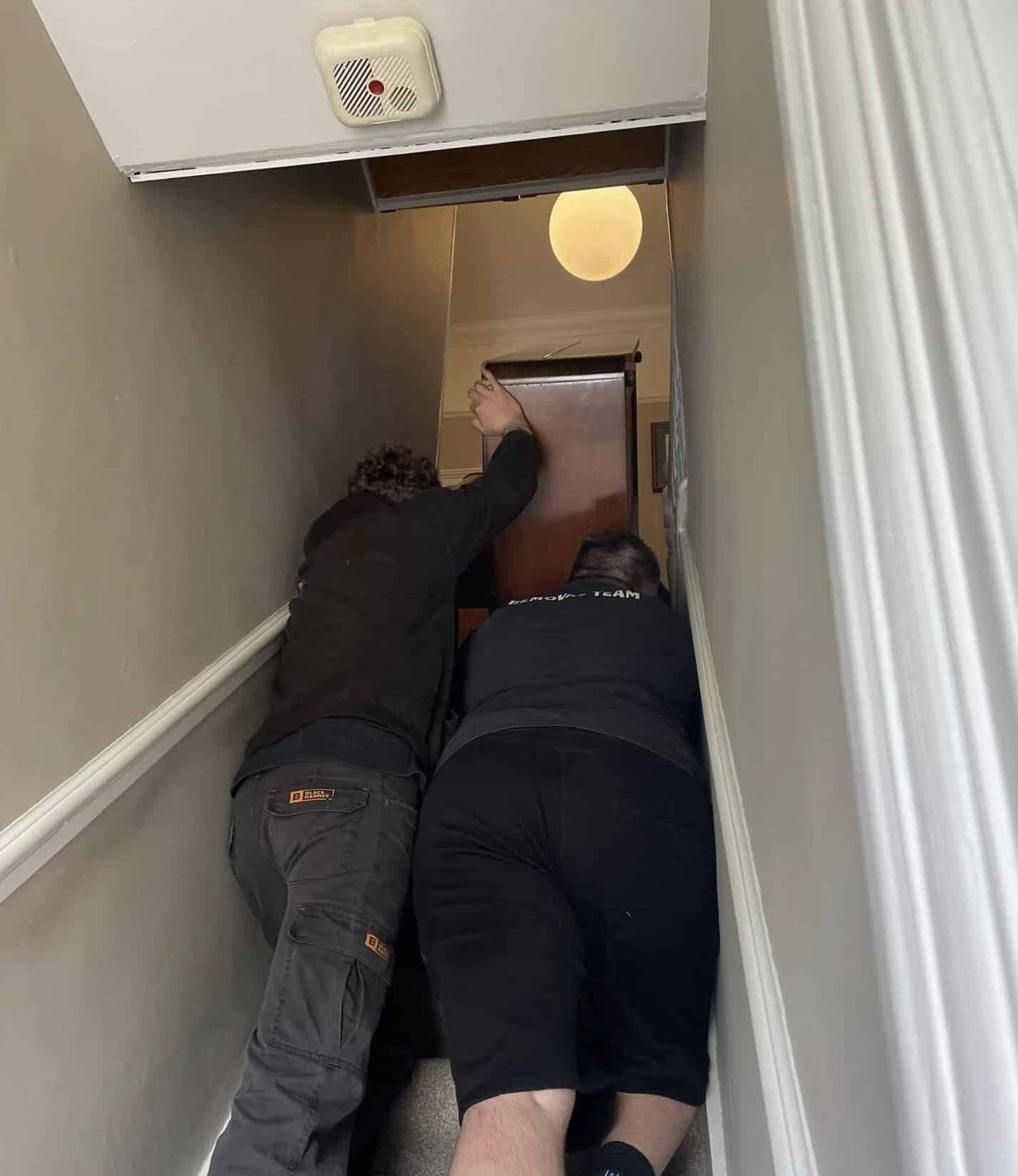 Removing a piano from upstairs for disposal
