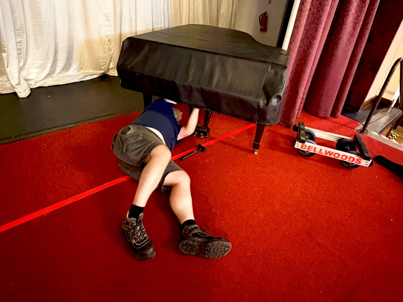 A Steinway grand piano being reassembled on the Civic Hall stage at Wallasey Town Hall